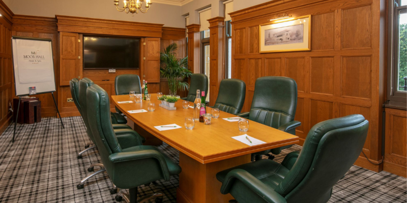 The Aston Room with its boardroom table and leather chairs