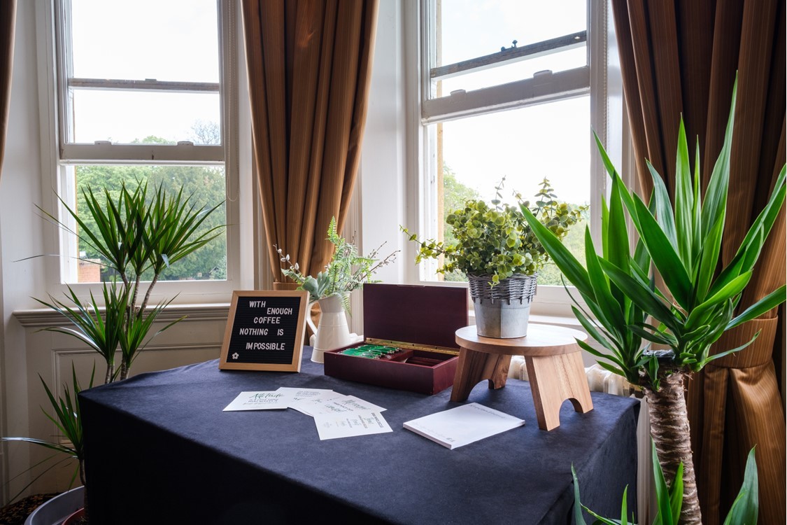 Refreshment table with plants beside meeting-room windows at Moor Hall